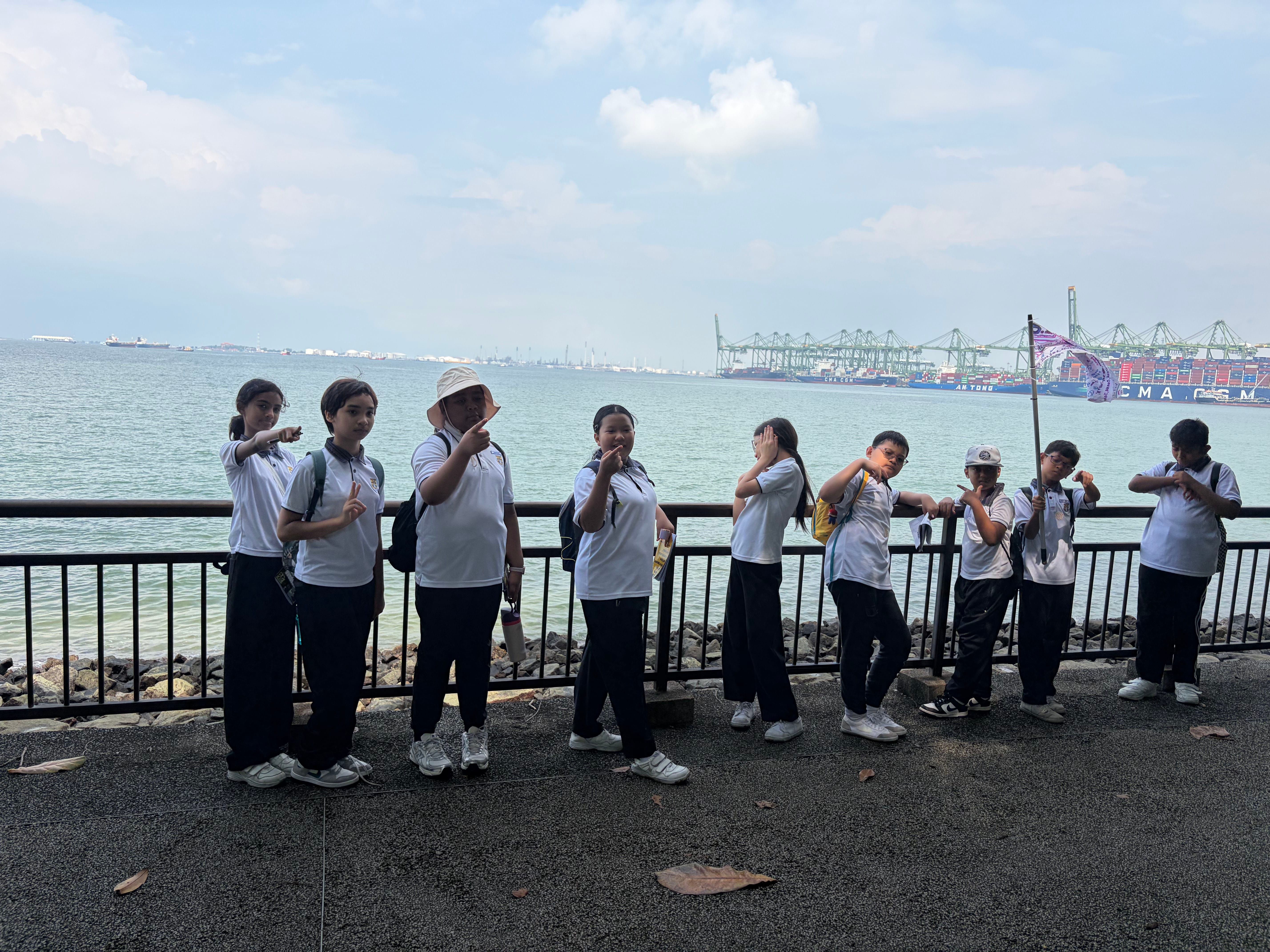 27. A quick group photo along the waterfront, with passing container ships providing a fitting backdrop.